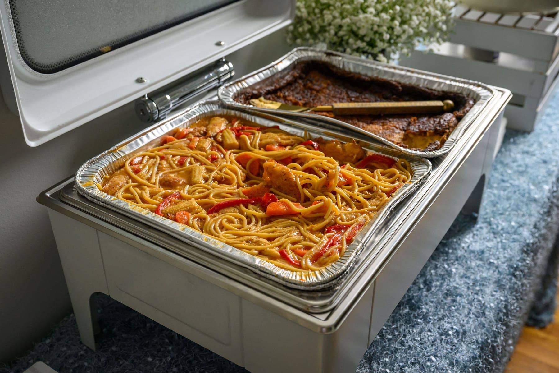 Spaghetti in a foil tray in a chafing dish