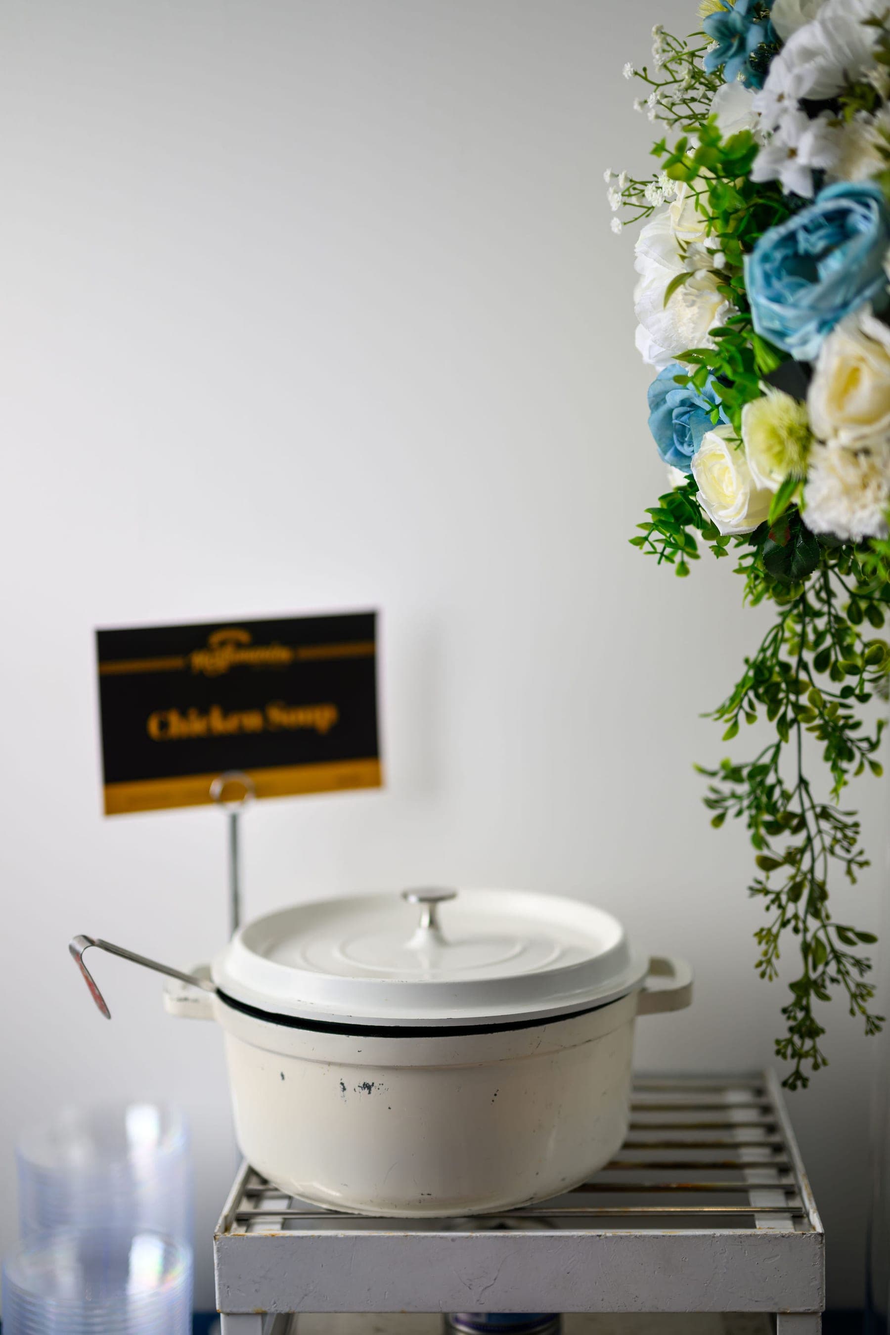 A Mashmanim card reading Chicken Soup, framed by white roses and gypsophila